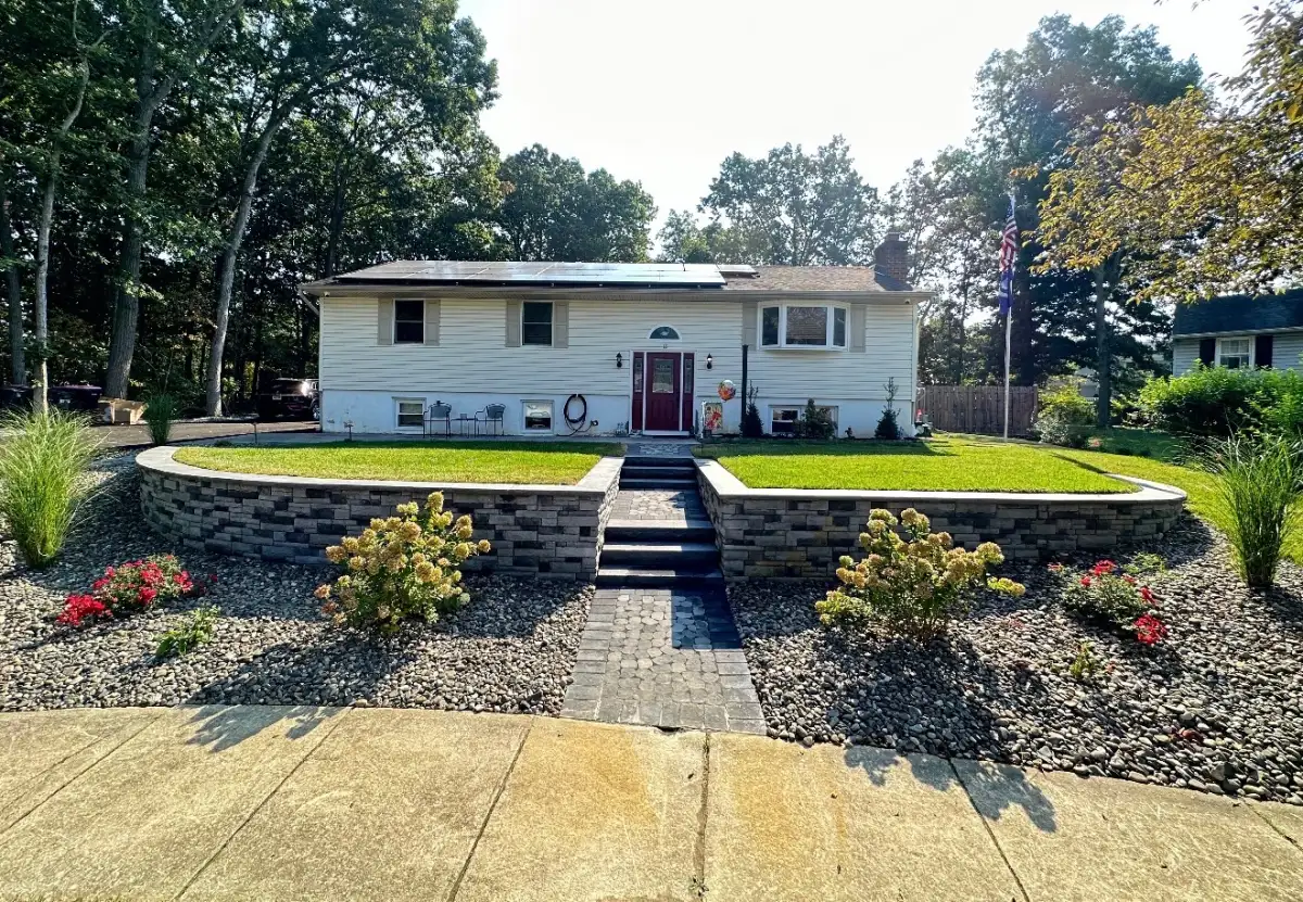 Curved retaining wall with paver steps and decorative rock in South Jersey