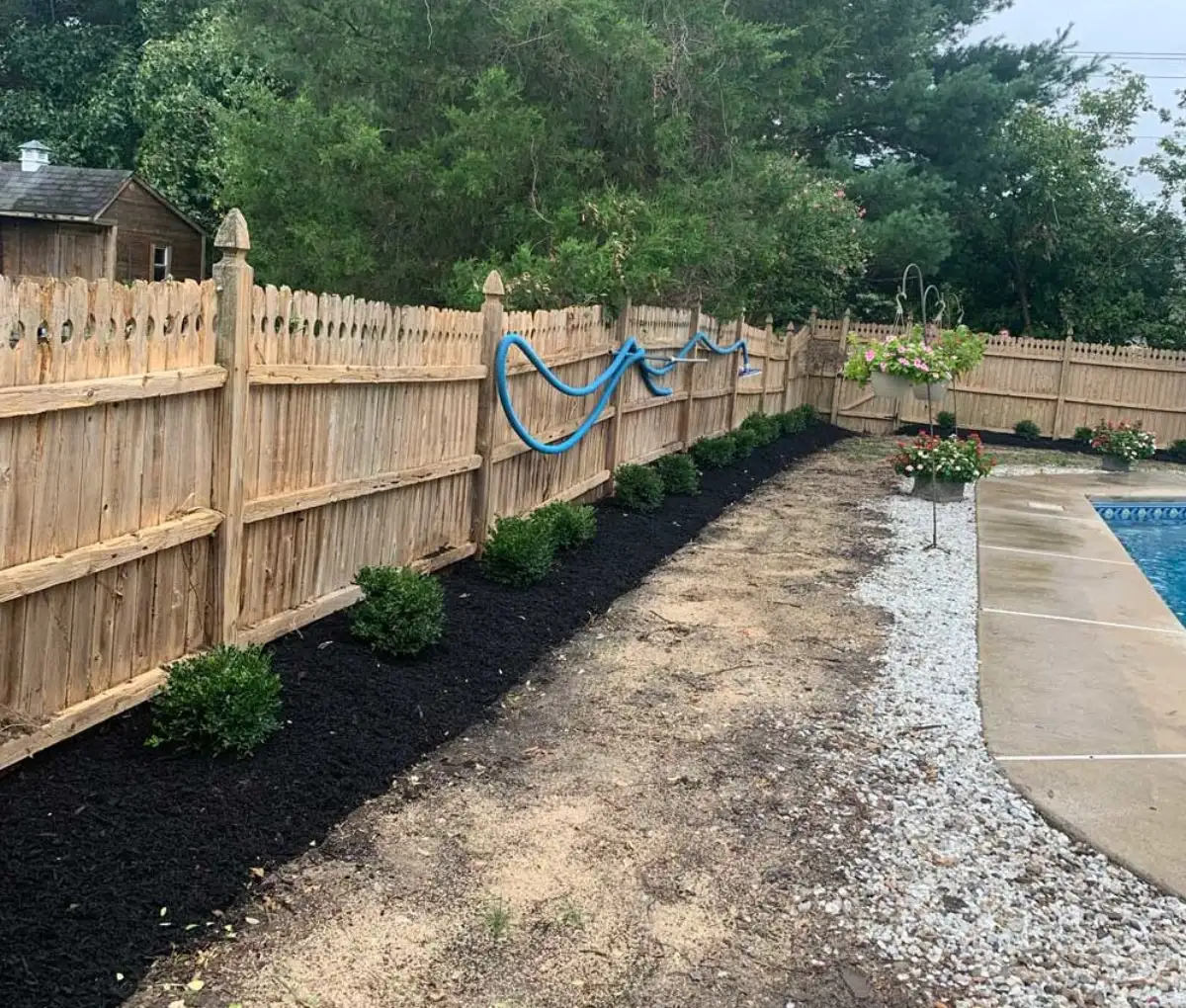Mulch and decorative rock installation around garden beds