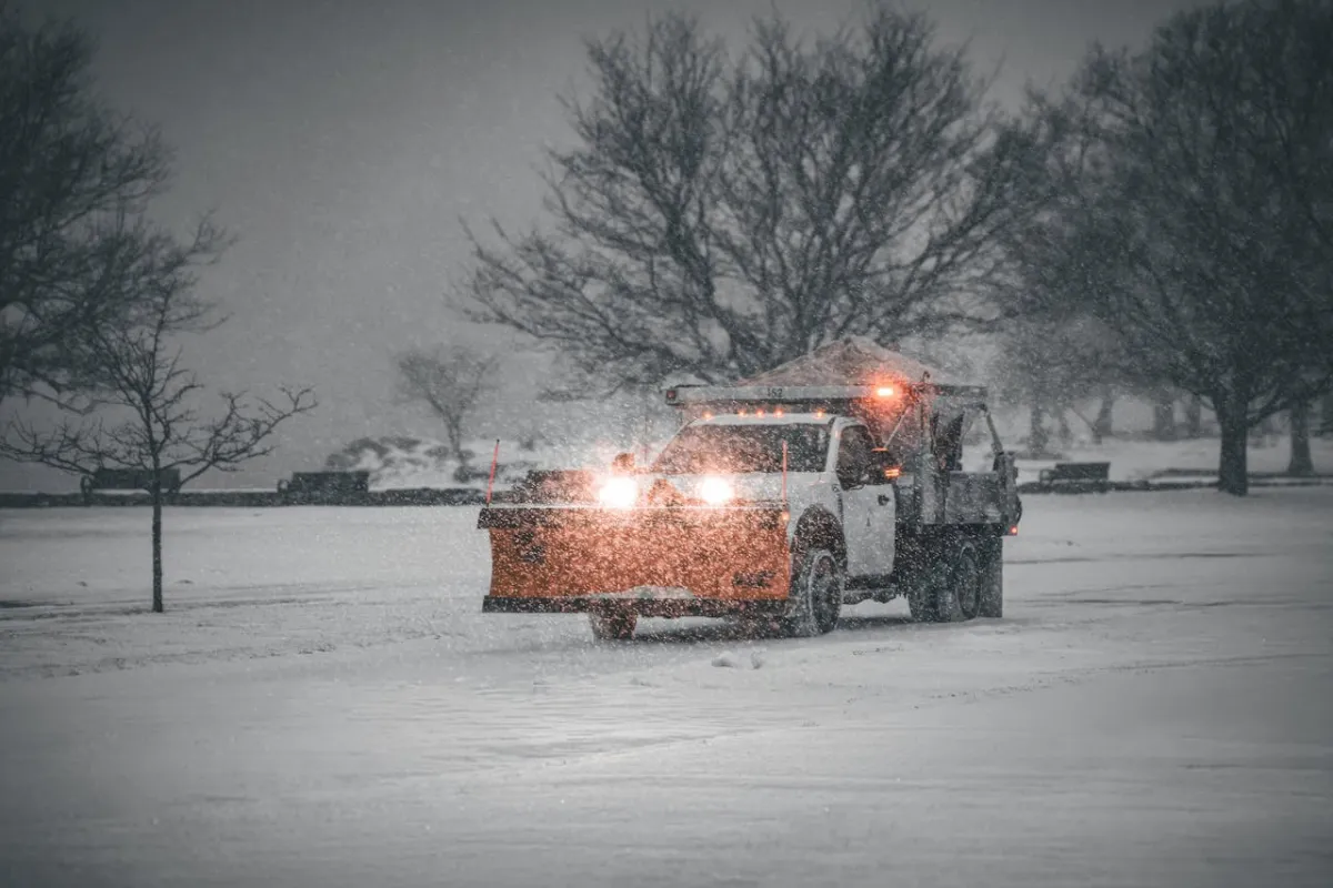 Commercial snow plow clearing a parking lot in South Jersey