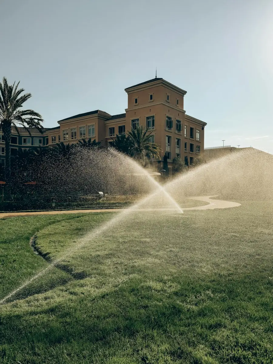 Sprinkler system watering a green lawn in South Jersey